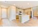 Bright kitchen featuring an island, stainless steel appliances, light cabinets, and wood-look flooring at 11840 Pelican Butte Ave, Las Vegas, NV 89138