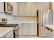 Well-equipped kitchen featuring stainless steel appliances, light countertops, and light wood cabinets at 11840 Pelican Butte Ave, Las Vegas, NV 89138