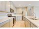 Elegant kitchen featuring stainless appliances, island sink, light countertops, and light wood cabinets at 11840 Pelican Butte Ave, Las Vegas, NV 89138