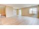 Bright living room with neutral walls, tile floors, and staircase access at 11840 Pelican Butte Ave, Las Vegas, NV 89138