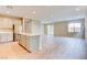Open floor plan with kitchen island, stainless steel appliances, and tile floors at 11840 Pelican Butte Ave, Las Vegas, NV 89138