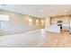 Bright and airy living space featuring light wood-look floors and an open floor plan to the kitchen at 11840 Pelican Butte Ave, Las Vegas, NV 89138