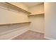 Walk-in closet featuring built-in shelving and carpeting at 11840 Pelican Butte Ave, Las Vegas, NV 89138