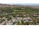 An aerial shot showcasing a neighborhood with beautiful homes, lush landscaping, golf course, and mountain views at 11926 Port Labelle Dr, Las Vegas, NV 89141