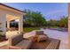 Inviting backyard with covered patio, seating area, and lush landscaping at 11926 Port Labelle Dr, Las Vegas, NV 89141
