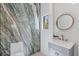 Stylish powder room features a vessel sink, round mirror, and marble accent wall at 11926 Port Labelle Dr, Las Vegas, NV 89141