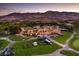 An aerial view of a magnificent clubhouse overlooking the golf course against a mountainous backdrop at 11926 Port Labelle Dr, Las Vegas, NV 89141