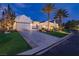 Elegant, light colored home featuring beautiful landscaping and a circular driveway at 11926 Port Labelle Dr, Las Vegas, NV 89141