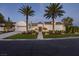 Stunning single-story home with a circular driveway, lush landscaping, and mature palm trees at 11926 Port Labelle Dr, Las Vegas, NV 89141