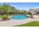 Inviting backyard pool with rock features and a well-manicured lawn in a luxury home at 11926 Port Labelle Dr, Las Vegas, NV 89141