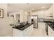 Modern kitchen with white cabinetry, stainless steel appliances, and a unique glass breakfast bar at 1339 Echo Creek St, Henderson, NV 89052
