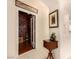 Elegant entryway to a custom wine cellar with a wooden rack and glass door at 1339 Echo Creek St, Henderson, NV 89052