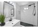 Updated bathroom featuring a rain shower head, modern tiles, and a sleek vanity at 1608 E Mcdonald Ave, North Las Vegas, NV 89030
