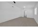 Spacious bedroom featuring neutral carpeting, ample natural light, and a ceiling fan at 1608 E Mcdonald Ave, North Las Vegas, NV 89030