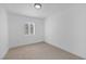 Bright bedroom with neutral carpet, fresh paint, and lots of natural light from the window at 1608 E Mcdonald Ave, North Las Vegas, NV 89030