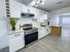 Bright kitchen with stainless steel appliances, subway tile backsplash, white cabinets, and breakfast bar at 1608 E Mcdonald Ave, North Las Vegas, NV 89030
