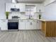 This remodeled kitchen features stainless steel appliances, white cabinets, and a charming wood-accented peninsula at 1608 E Mcdonald Ave, North Las Vegas, NV 89030