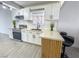 Beautifully updated kitchen featuring white cabinets, a breakfast bar, and stainless steel appliances at 1608 E Mcdonald Ave, North Las Vegas, NV 89030