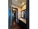 Elegant bathroom with dark wood cabinets, granite counters and hard wood flooring at 1800 Amarone Way, Henderson, NV 89012