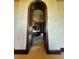 Arched doorway leads to an opulent bathroom with marble countertops and dark wood cabinetry at 1800 Amarone Way, Henderson, NV 89012