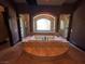 Spa-like bathroom with a soaking tub, walk-in showers on either side, and neutral colors at 1800 Amarone Way, Henderson, NV 89012