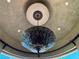 Close-up of an ornate chandelier hanging from a decorative ceiling at 1800 Amarone Way, Henderson, NV 89012