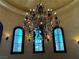 A crystal chandelier dangles above a curved staircase at 1800 Amarone Way, Henderson, NV 89012