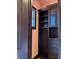 Elegant closet with a dark wood cabinet with drawers, shelving and glass at 1800 Amarone Way, Henderson, NV 89012