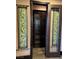 View into closet with built-in storage cabinets and art-glass decorated doors at 1800 Amarone Way, Henderson, NV 89012