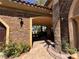 Exterior entrance featuring decorative stonework, custom lighting, and desert landscaping at 1800 Amarone Way, Henderson, NV 89012