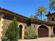 Close-up of the home's exterior, showcasing the beautiful stone accents and manicured greenery at 1800 Amarone Way, Henderson, NV 89012