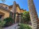 Beautiful Mediterranean-style home featuring an arched gate, stone accents, and meticulous landscaping at 1800 Amarone Way, Henderson, NV 89012
