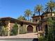 Elegant home with lush landscaping, driveway, and a Mediterranean-style design at 1800 Amarone Way, Henderson, NV 89012