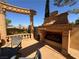 Outdoor fireplace and seating area providing a cozy and elegant space for relaxation and socializing at 1800 Amarone Way, Henderson, NV 89012