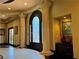 Grand foyer entrance with stone pillars, decorative door, and elegant finishes at 1800 Amarone Way, Henderson, NV 89012