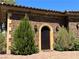 Beautiful front door with decorative sconces and manicured landscaping at 1800 Amarone Way, Henderson, NV 89012
