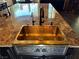 Elegant kitchen sink featuring an antique brass finish with a grape motif, and granite countertops at 1800 Amarone Way, Henderson, NV 89012