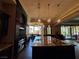Gourmet kitchen with custom cabinets, stone countertops and designer lighting at 1800 Amarone Way, Henderson, NV 89012
