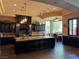 Gourmet kitchen with custom cabinets, large center island, and pendant lighting at 1800 Amarone Way, Henderson, NV 89012