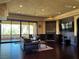 An elegant living room with dark wood floors and a cozy fireplace at 1800 Amarone Way, Henderson, NV 89012