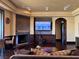 A well-lit living room featuring dark wood floors and fireplace at 1800 Amarone Way, Henderson, NV 89012