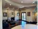 Cozy living room with stone fireplace, dark hardwood floors, and natural light at 1800 Amarone Way, Henderson, NV 89012