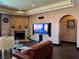 Spacious living room featuring a fireplace, a large TV, a leather couch, and recessed lighting at 1800 Amarone Way, Henderson, NV 89012