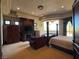 Luxurious main bedroom with a fireplace, balcony access, and elegant furnishings for relaxation at 1800 Amarone Way, Henderson, NV 89012