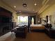 Beautiful main bedroom with a fireplace, seating area, and a four-poster bed at 1800 Amarone Way, Henderson, NV 89012