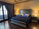 Comfortable main bedroom with hardwood floors, french doors, and two nightstands at 1800 Amarone Way, Henderson, NV 89012