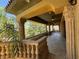 Spacious covered patio area with decorative columns, stone balustrade, and outdoor ceiling fans at 1800 Amarone Way, Henderson, NV 89012