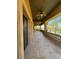 Covered patio features stone columns, travertine tile flooring, and outdoor ceiling fans at 1800 Amarone Way, Henderson, NV 89012