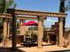 Outdoor entertaining area with a fireplace and dining under a pergola, ideal for outdoor living at 1800 Amarone Way, Henderson, NV 89012