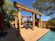 Inviting pool area with an elaborate stone pergola and outdoor kitchen providing a luxurious experience at 1800 Amarone Way, Henderson, NV 89012